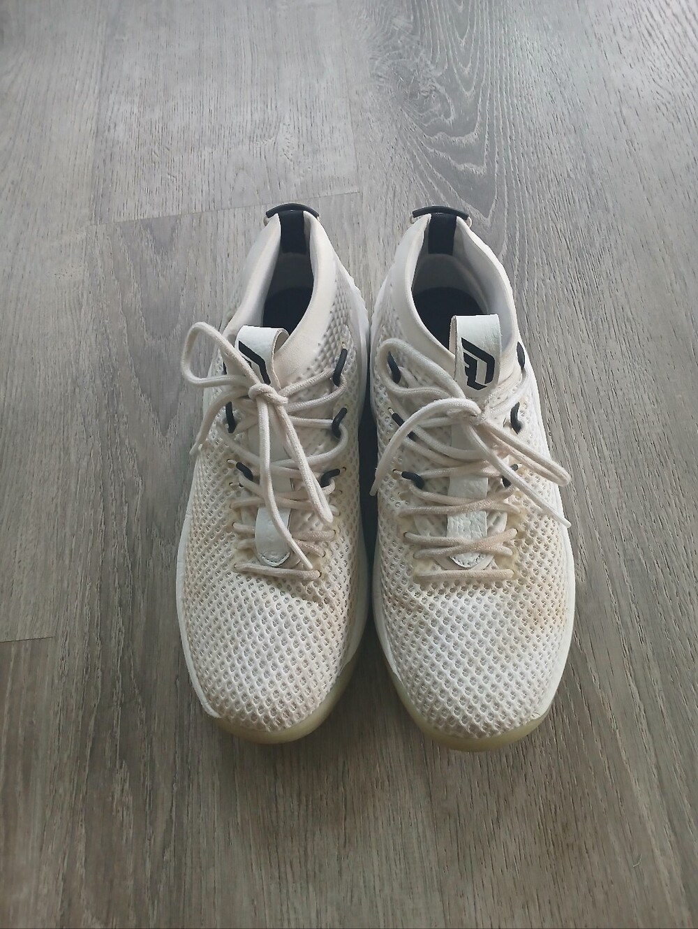 adidas Dame 4 'Un-Dyed' white basketball shoes.
